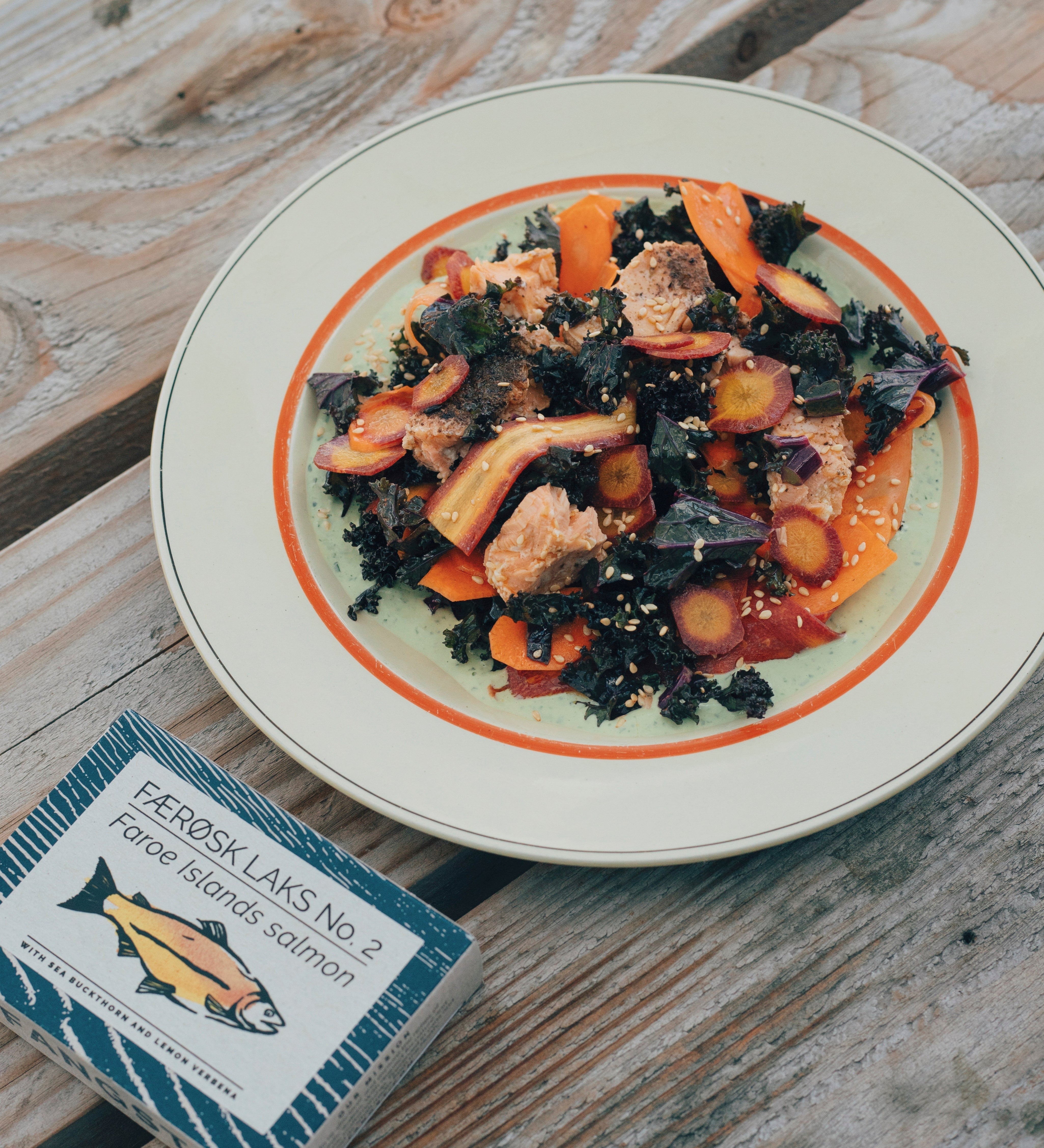 Kale salad with green tahini, sesame seeds and salmon
