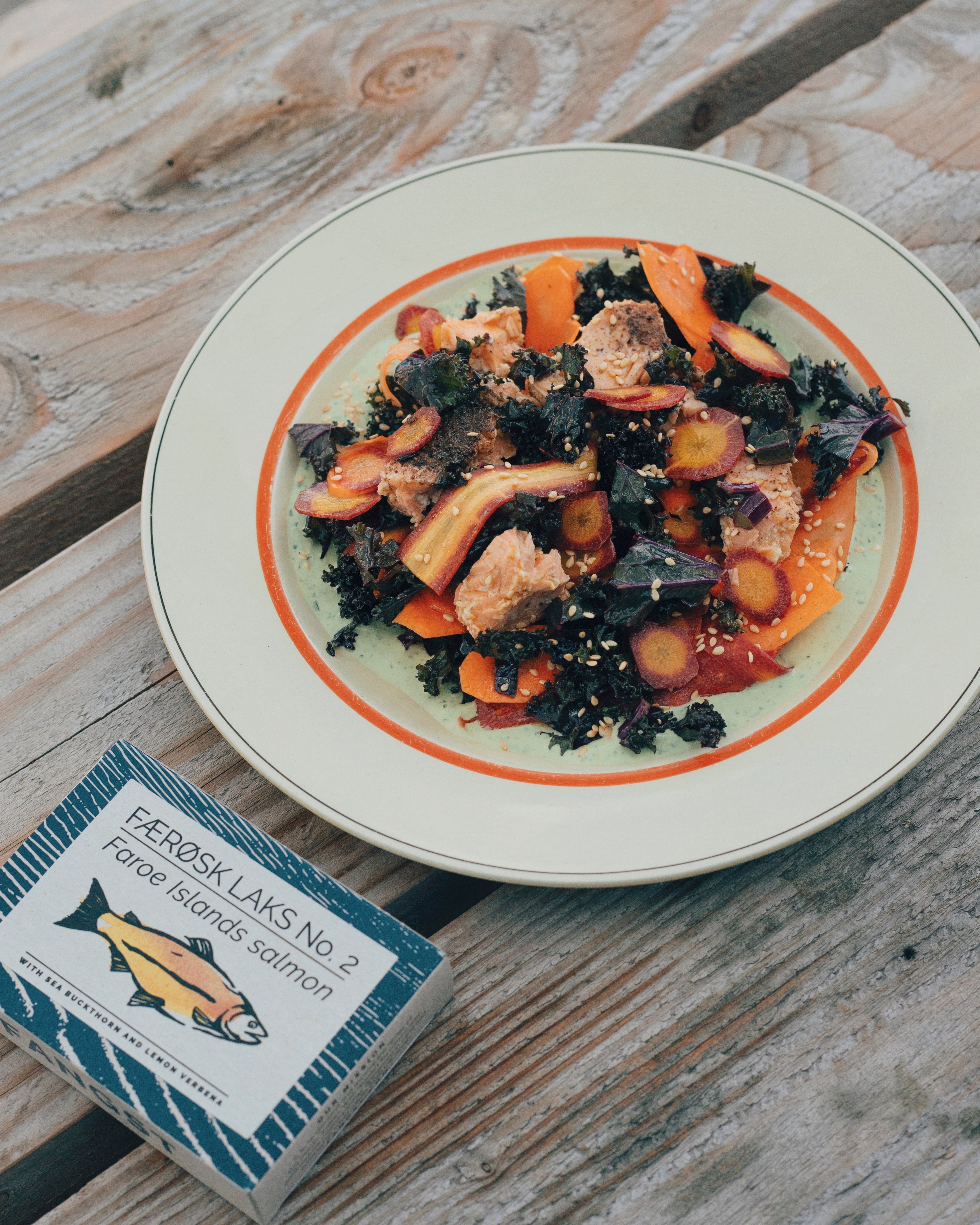 Kale salad with green tahini, sesame seeds and salmon
