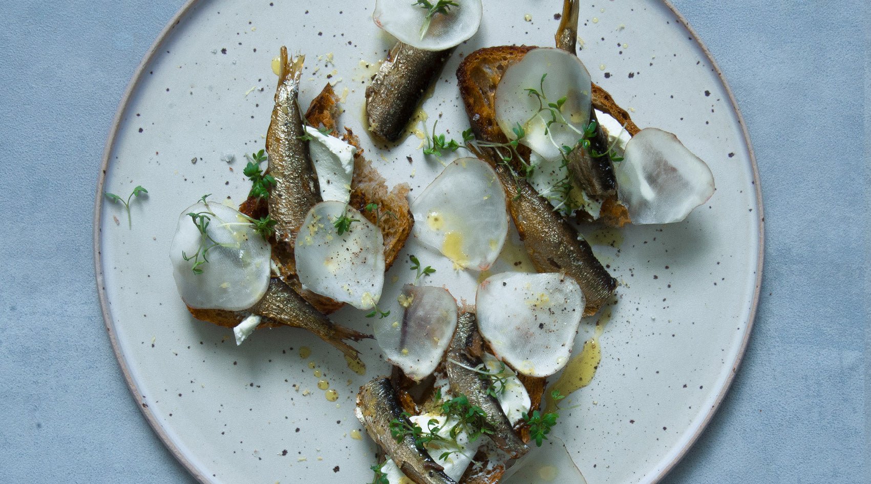 Nordic sardines on grilled bread with fresh cheese - FANGST